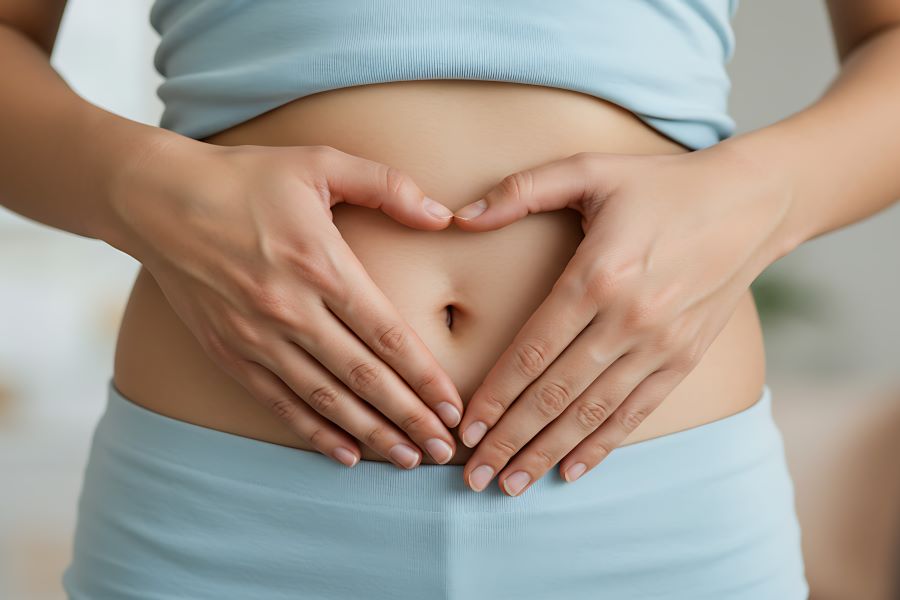 woman holding hands on stomach for gut brain skin axis